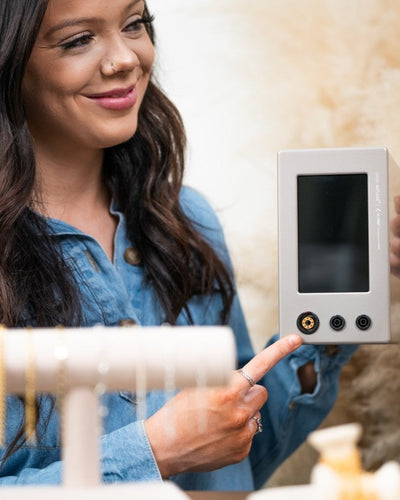 Woman holding a microwelder in a home setting
